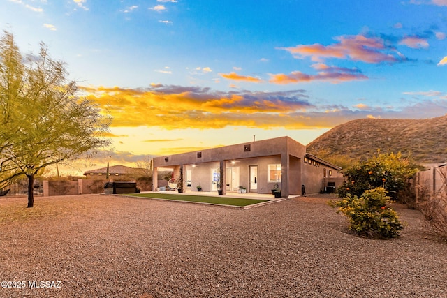 back house at dusk featuring a mountain view