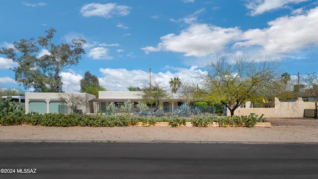 view of front of home featuring a fenced front yard and stucco siding