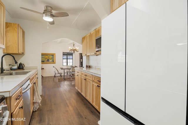 kitchen featuring arched walkways, dark wood-style floors, appliances with stainless steel finishes, light brown cabinetry, and a sink