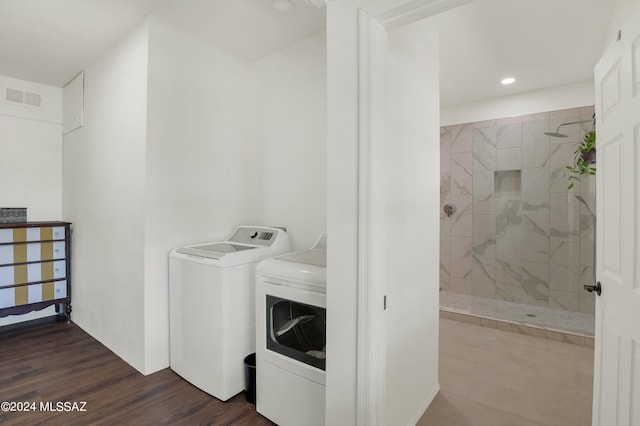 laundry room featuring recessed lighting, laundry area, dark wood-type flooring, visible vents, and washing machine and clothes dryer