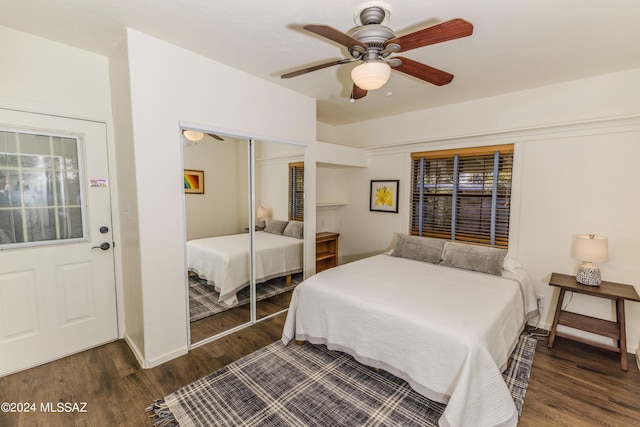 bedroom with ceiling fan, a closet, wood finished floors, and baseboards