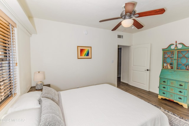 bedroom featuring ceiling fan, wood finished floors, and visible vents