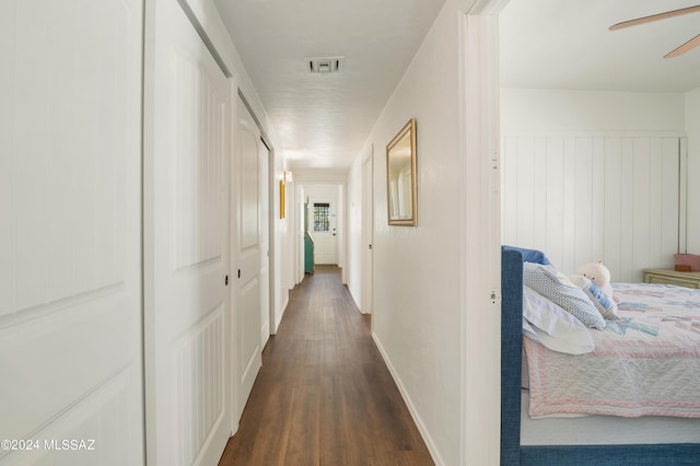 hallway with visible vents and dark wood-style flooring