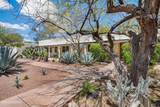 view of front of home with a porch and stucco siding