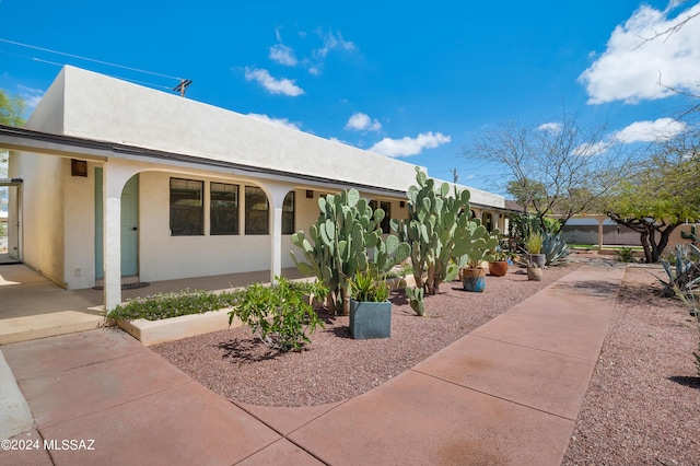 pueblo revival-style home featuring stucco siding