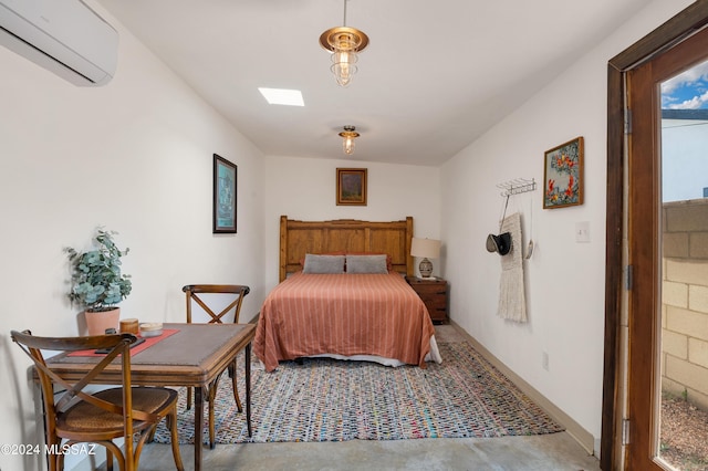 bedroom featuring an AC wall unit and concrete floors