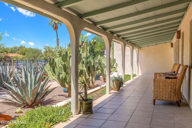 view of patio featuring fence