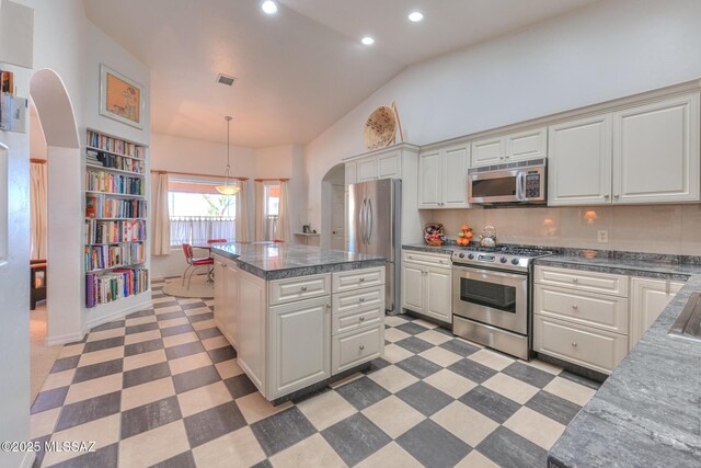 kitchen with visible vents, light floors, recessed lighting, arched walkways, and stainless steel appliances