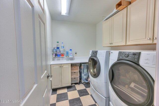 washroom featuring tile patterned floors, washing machine and dryer, and cabinet space