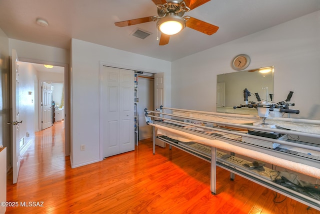 interior space featuring visible vents, light wood finished floors, and ceiling fan