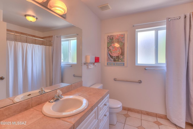 full bathroom with visible vents, plenty of natural light, toilet, and vanity