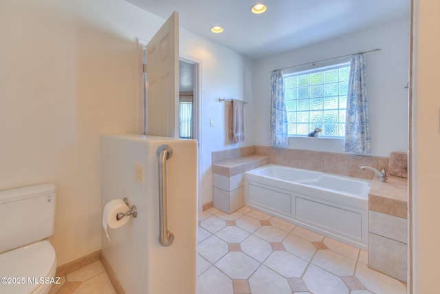 bathroom featuring recessed lighting, a garden tub, toilet, and tile patterned flooring