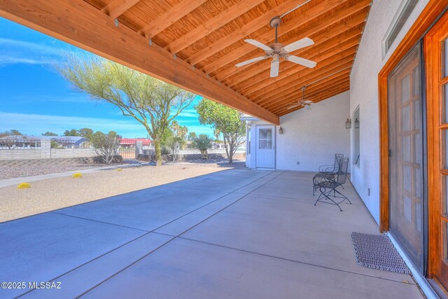 view of patio with a ceiling fan and fence