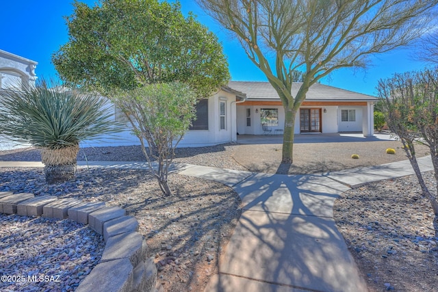 view of front of home with french doors and stucco siding