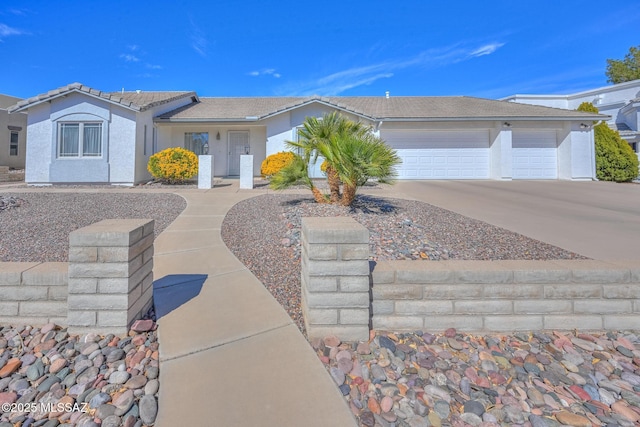 ranch-style home featuring a tile roof, an attached garage, driveway, and stucco siding