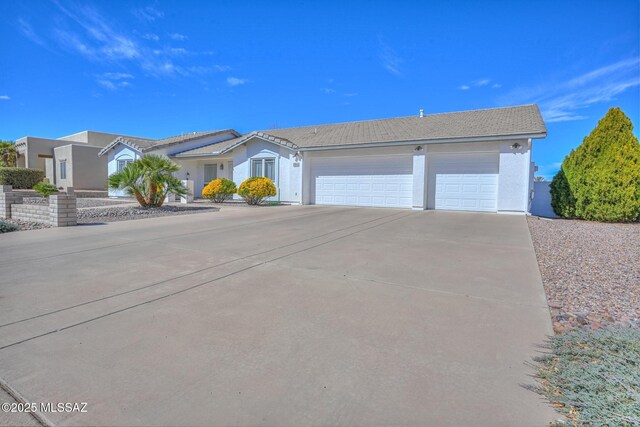 ranch-style house featuring a garage, driveway, and stucco siding