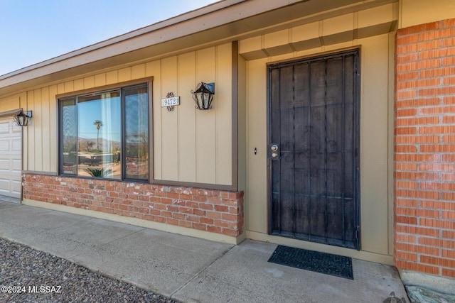 view of exterior entry with a garage