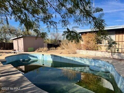 view of pool with an outbuilding and a patio area