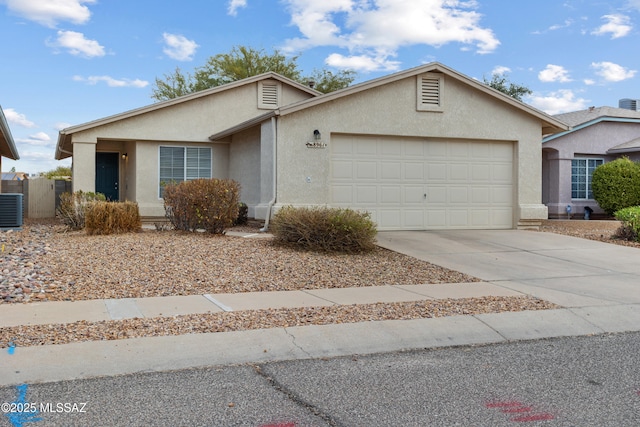 ranch-style house featuring a garage and central AC unit