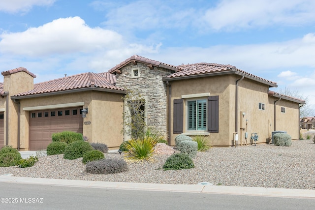 mediterranean / spanish house featuring a garage