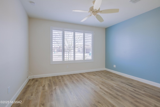 unfurnished room with ceiling fan and light wood-type flooring