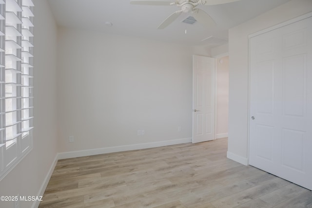 empty room featuring ceiling fan and light wood-type flooring