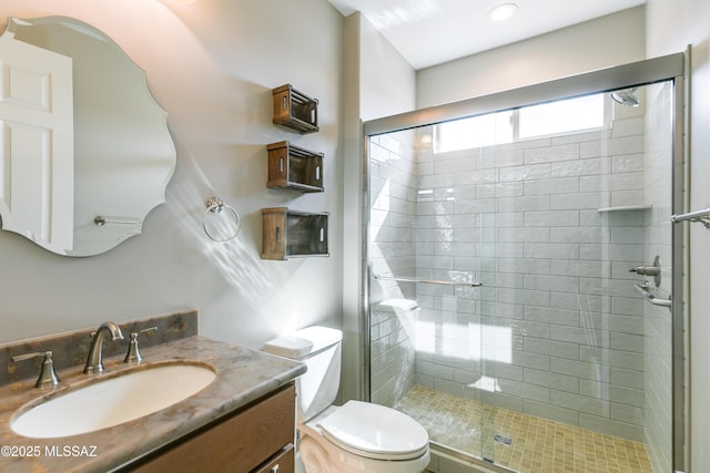 bathroom featuring walk in shower, vanity, and toilet