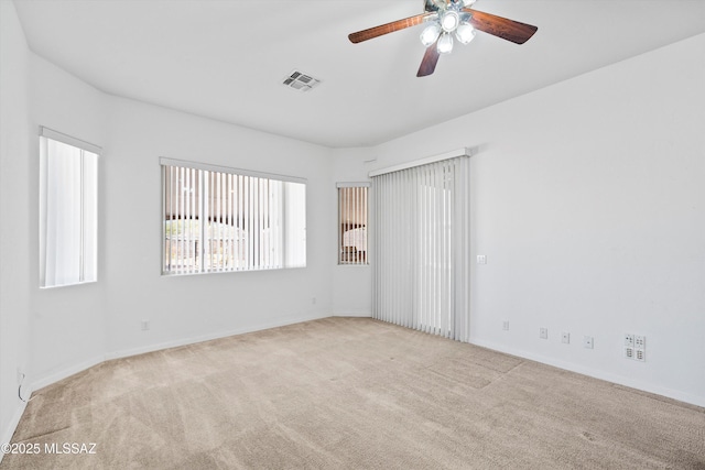 carpeted spare room with ceiling fan