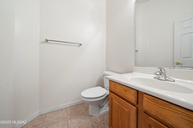 bathroom with vanity, tile patterned floors, and toilet