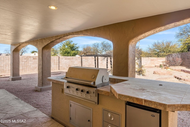 view of patio / terrace featuring a grill and exterior kitchen