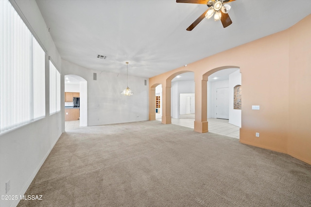 unfurnished room with ceiling fan and light colored carpet