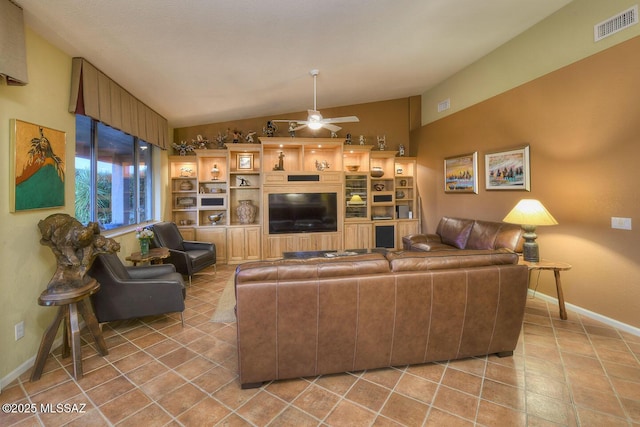 living room with a ceiling fan, visible vents, vaulted ceiling, and light tile patterned flooring