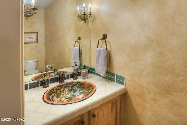 bathroom with toilet and vanity