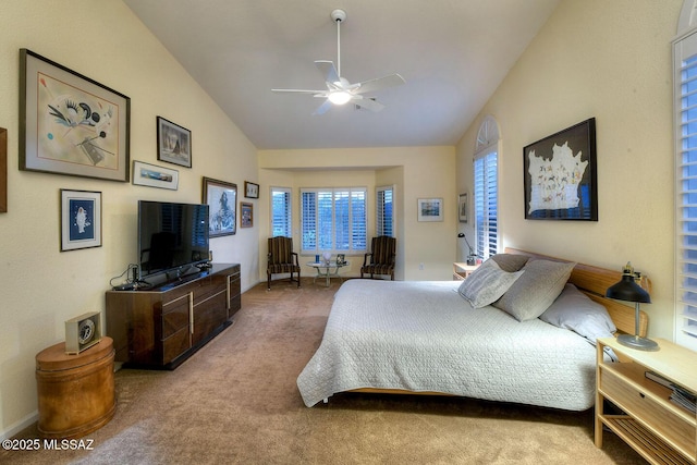 carpeted bedroom featuring high vaulted ceiling and baseboards