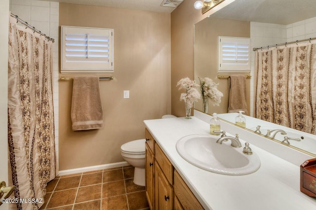 bathroom with visible vents, toilet, vanity, tile patterned flooring, and baseboards