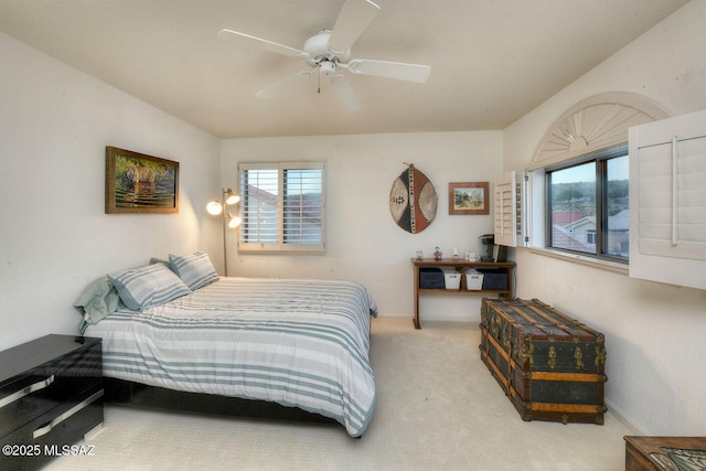 carpeted bedroom featuring ceiling fan and baseboards