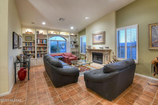 living area with lofted ceiling, tile patterned flooring, built in shelves, and a premium fireplace