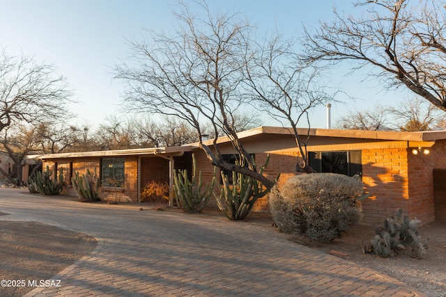 mid-century modern home with brick siding