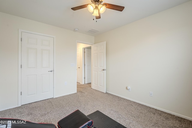 interior space featuring ceiling fan and light colored carpet