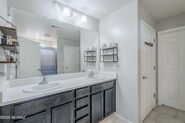 bathroom with vanity, tile patterned floors, and walk in shower