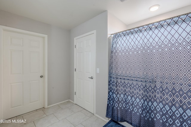 bathroom featuring tile patterned flooring and walk in shower