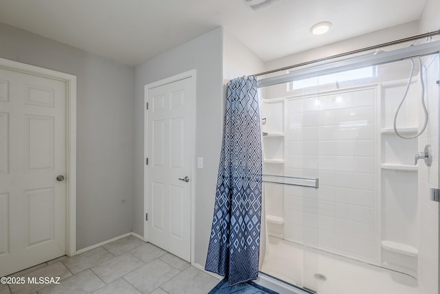 bathroom featuring tile patterned flooring and walk in shower