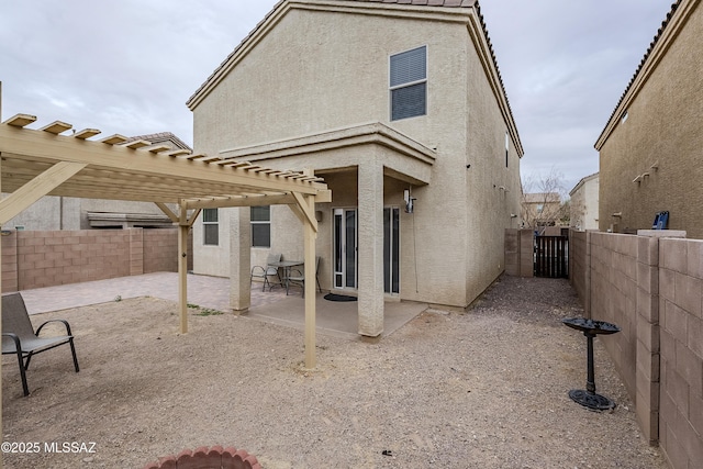 rear view of house with a pergola and a patio