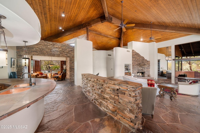 view of patio / terrace featuring sink, ceiling fan, and a fireplace