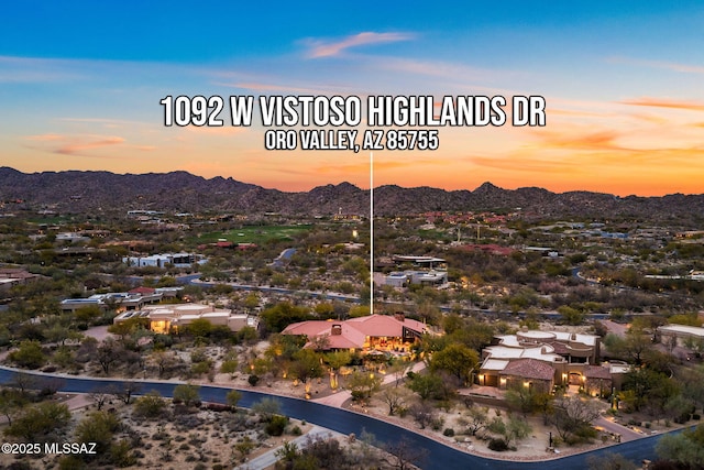 aerial view at dusk featuring a mountain view