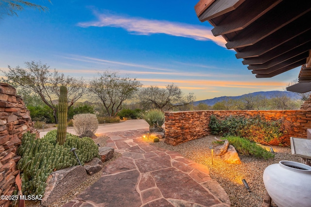 patio terrace at dusk with a mountain view