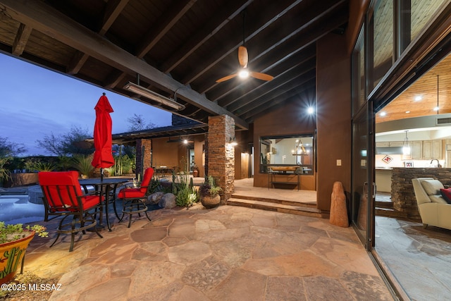 patio terrace at dusk featuring ceiling fan and sink