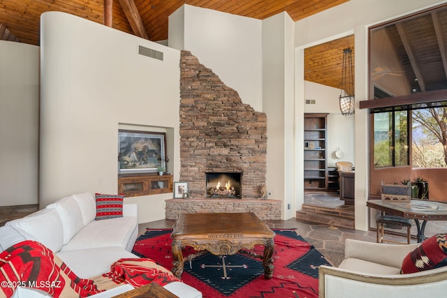 living room featuring high vaulted ceiling, a stone fireplace, and wooden ceiling