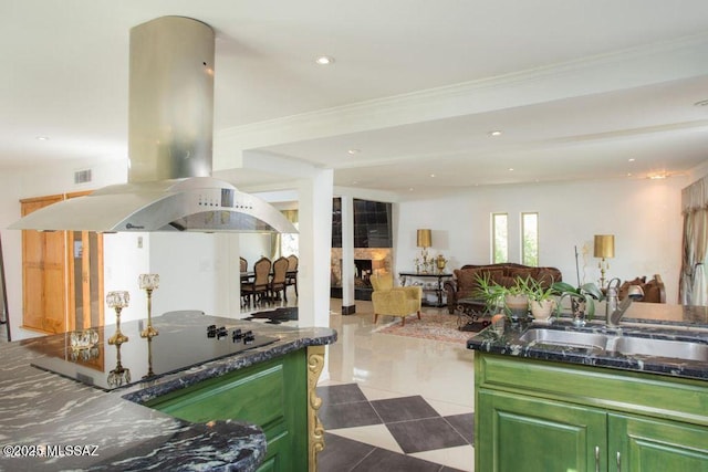 kitchen with sink, green cabinets, island range hood, black electric cooktop, and tile patterned floors