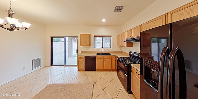 kitchen with sink, light tile patterned floors, black appliances, decorative light fixtures, and light brown cabinets